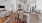 Spacious well lit kitchen with wood floors and stainless steel appliances
