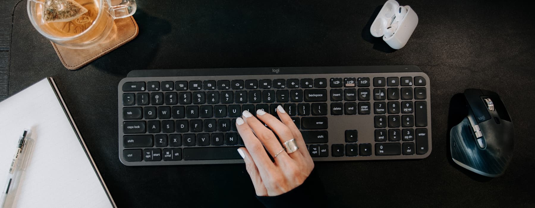 lifestyle image of a woman's hand typing on a keyboard
